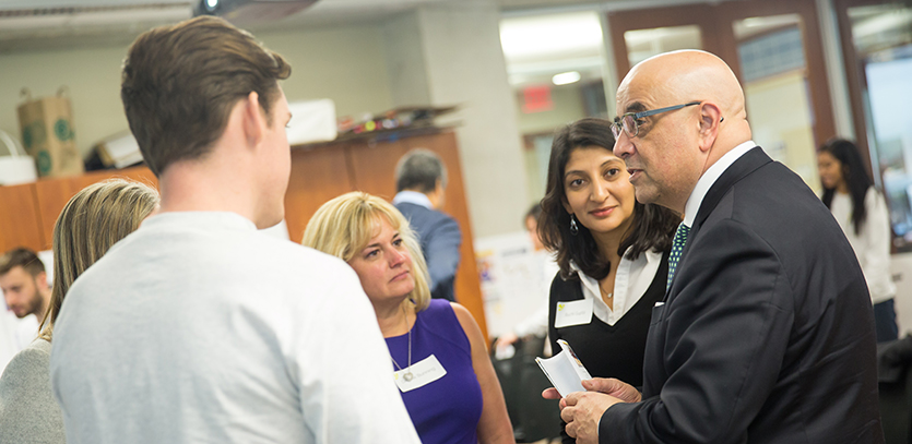 Dean Ottino speaks with EDI student Ryan Callaghan and Dr. Ruchi Gupta after the presentations.