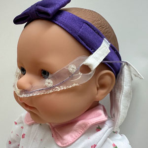 The team's final prototype included a silicone NG tube holder, adjustable headband, and storage pouch for excess tubing.